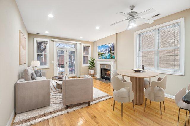 living room with ceiling fan and light wood-type flooring