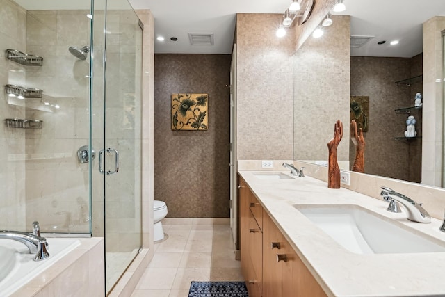 full bathroom with tile patterned flooring, vanity, plus walk in shower, and toilet