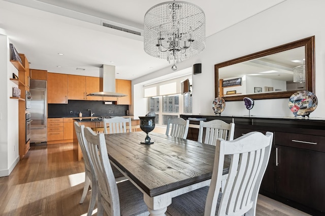 dining room featuring an inviting chandelier and light hardwood / wood-style flooring