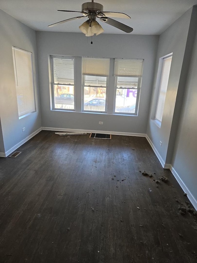 spare room with ceiling fan and dark hardwood / wood-style floors