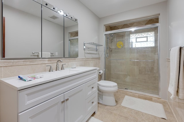 bathroom with vanity, toilet, tile patterned flooring, and a shower with door