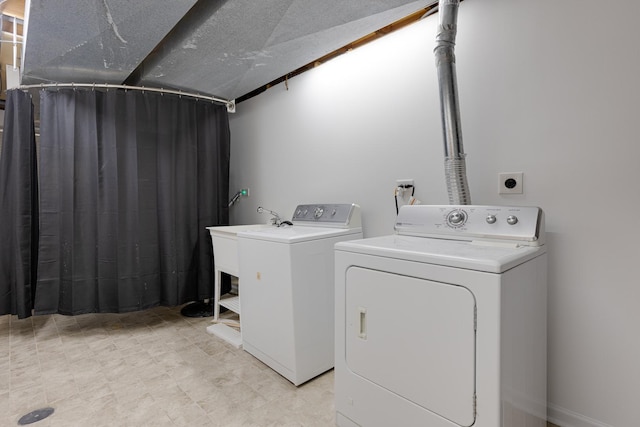 laundry area featuring washer and dryer and sink