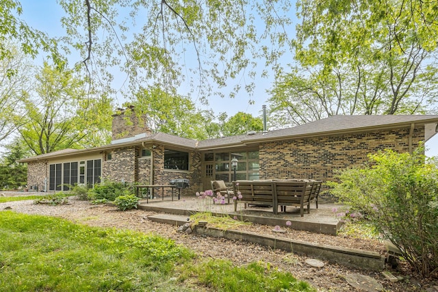 back of property with outdoor lounge area and a patio