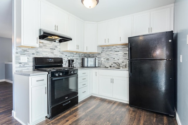 kitchen featuring black appliances, dark hardwood / wood-style floors, tasteful backsplash, and white cabinetry