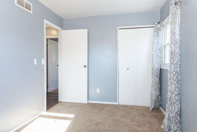 unfurnished bedroom featuring a closet and carpet flooring