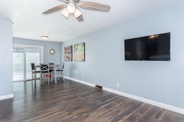 dining space with ceiling fan and dark hardwood / wood-style flooring