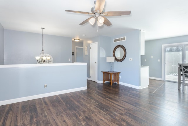 interior space with dark hardwood / wood-style floors and ceiling fan with notable chandelier