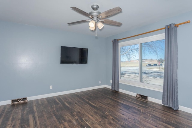 unfurnished room with ceiling fan and dark wood-type flooring