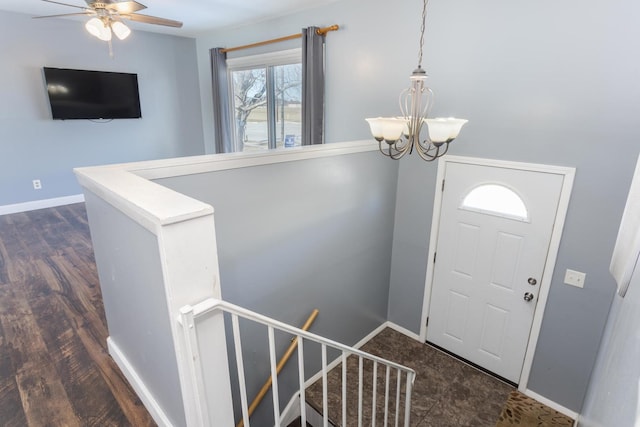 entrance foyer featuring dark hardwood / wood-style flooring and ceiling fan with notable chandelier