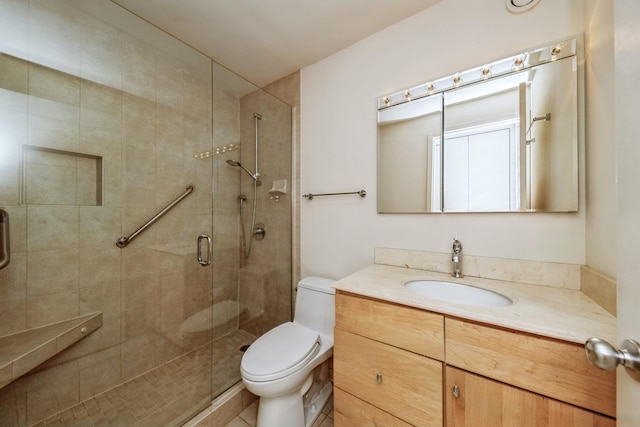 bathroom with toilet, walk in shower, and vanity