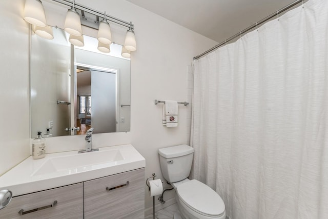 bathroom featuring toilet and vanity