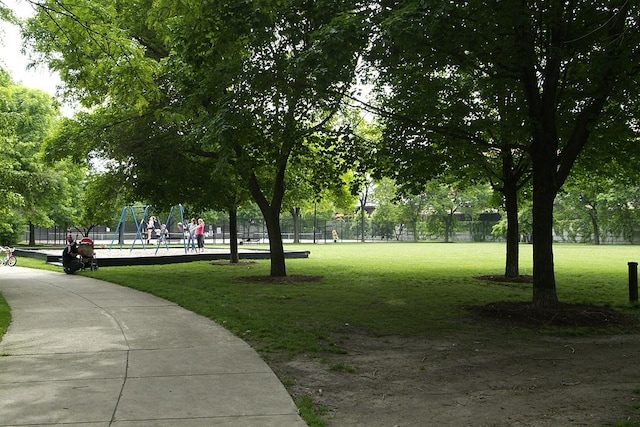 surrounding community with a lawn and a playground