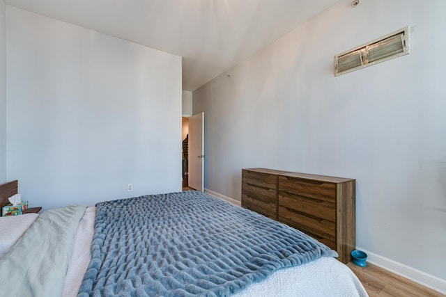 bedroom with hardwood / wood-style flooring