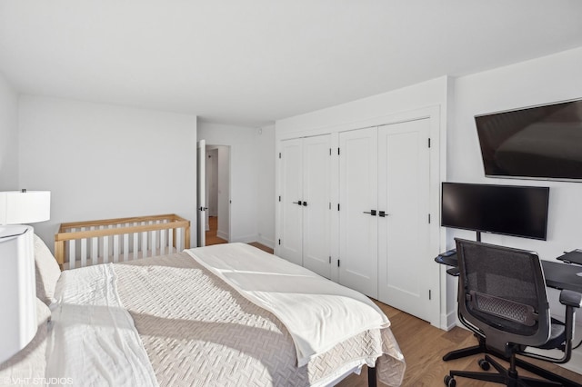 bedroom with light hardwood / wood-style floors and a closet