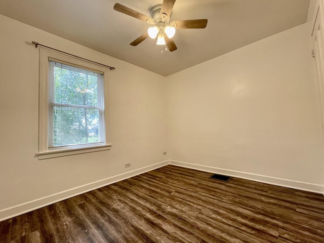 unfurnished room with ceiling fan and dark hardwood / wood-style flooring