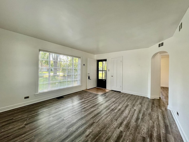 unfurnished room featuring dark wood-type flooring