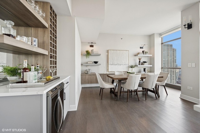 dining room featuring floor to ceiling windows, dark hardwood / wood-style floors, and washer / clothes dryer