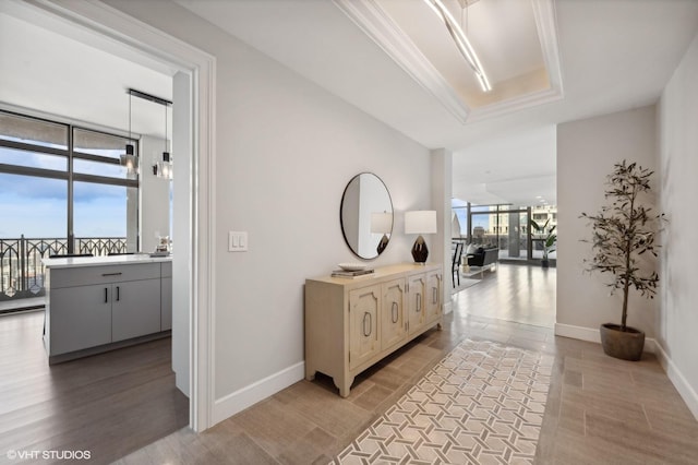 hallway featuring ornamental molding and expansive windows