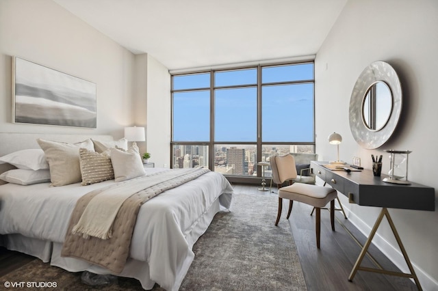 bedroom featuring dark wood-type flooring and floor to ceiling windows