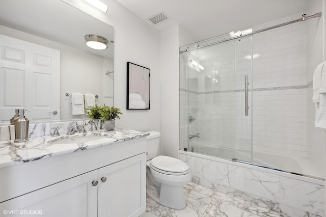 full bathroom featuring shower / bath combination with glass door, vanity, and toilet