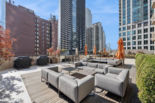 deck featuring grilling area, a patio area, and outdoor lounge area