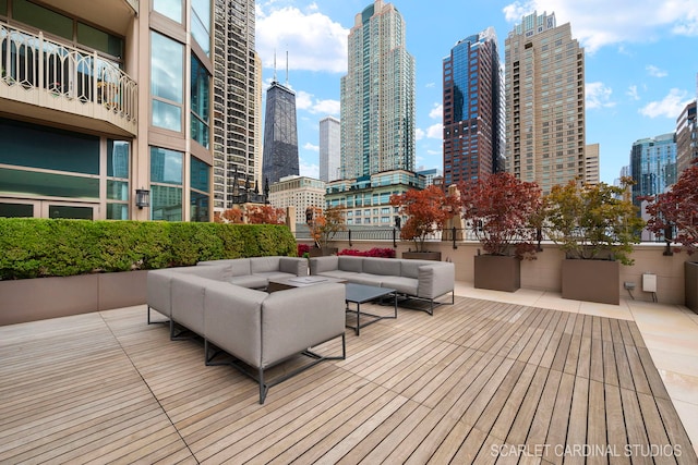 wooden deck with a patio area and outdoor lounge area