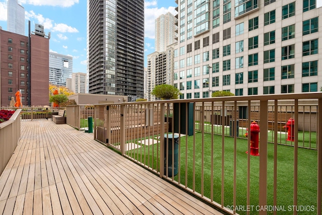 wooden terrace featuring a yard