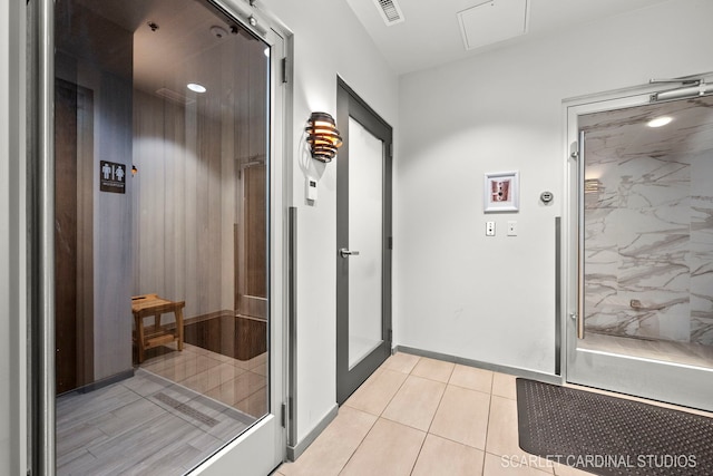 hallway featuring light tile patterned floors