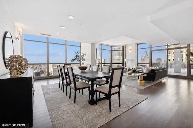 dining area featuring expansive windows and dark hardwood / wood-style flooring