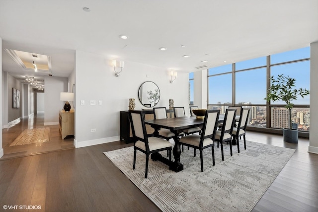 dining space with expansive windows and dark hardwood / wood-style floors