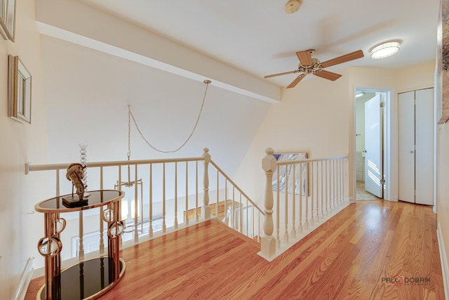 hall featuring lofted ceiling with beams and light hardwood / wood-style floors