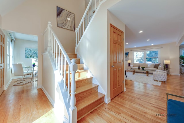 stairs featuring hardwood / wood-style floors