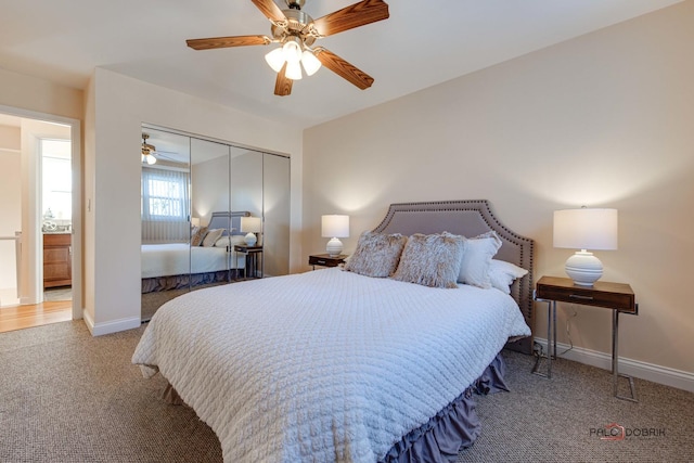 carpeted bedroom featuring ceiling fan and a closet