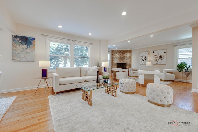 living room featuring a fireplace and light hardwood / wood-style flooring