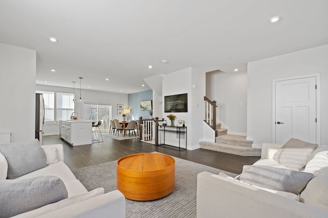 living room featuring dark hardwood / wood-style flooring and sink