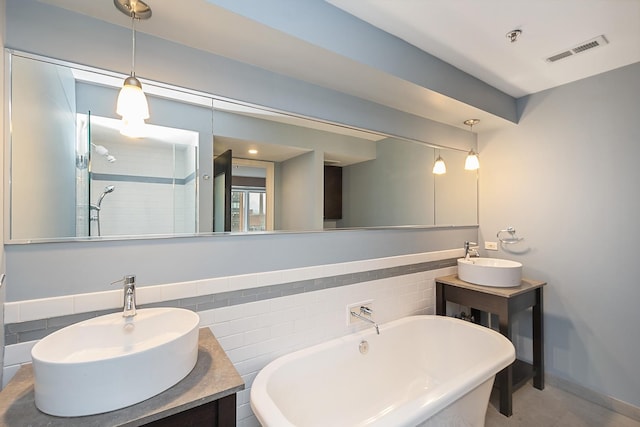 bathroom with vanity, plus walk in shower, and tile walls