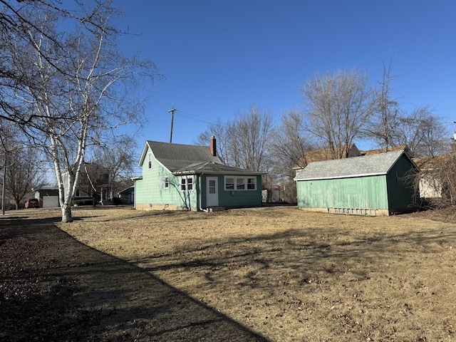 rear view of property featuring a lawn