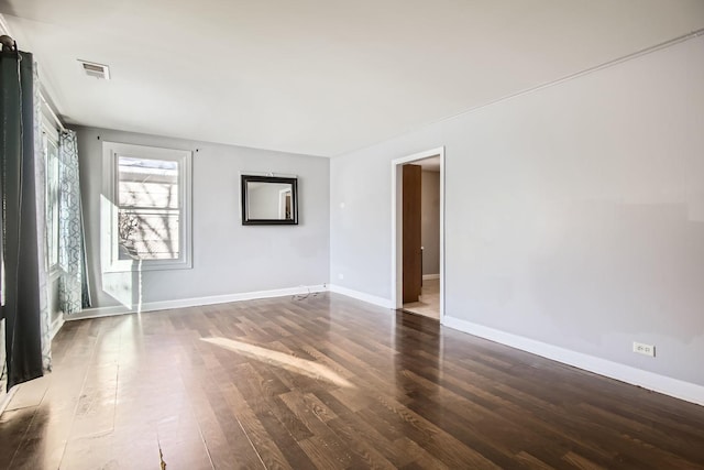 spare room featuring dark wood-type flooring