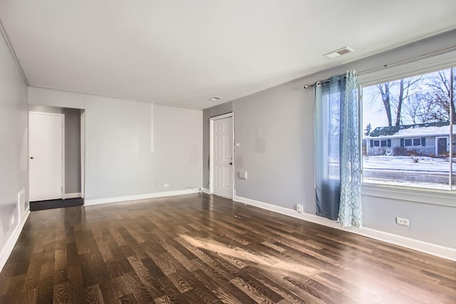 unfurnished room with dark hardwood / wood-style flooring