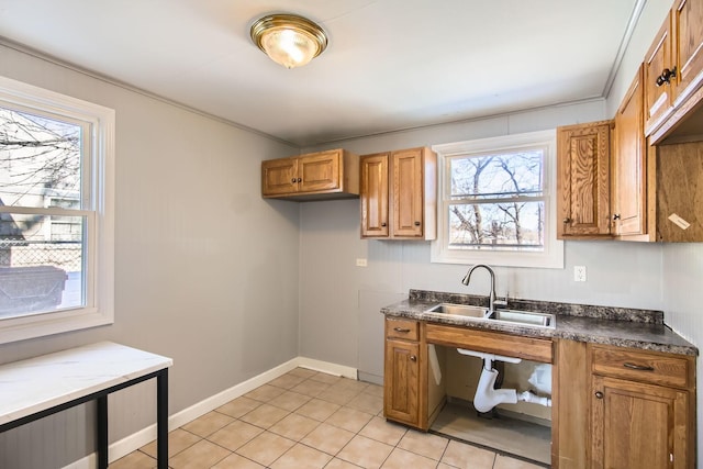 kitchen featuring light tile patterned floors, plenty of natural light, and sink