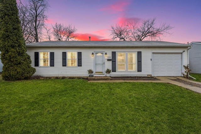 single story home with a lawn and a garage