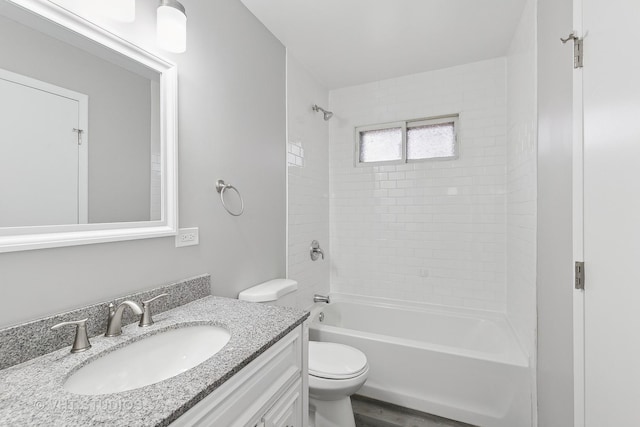 full bathroom with vanity, toilet, and tiled shower / bath combo