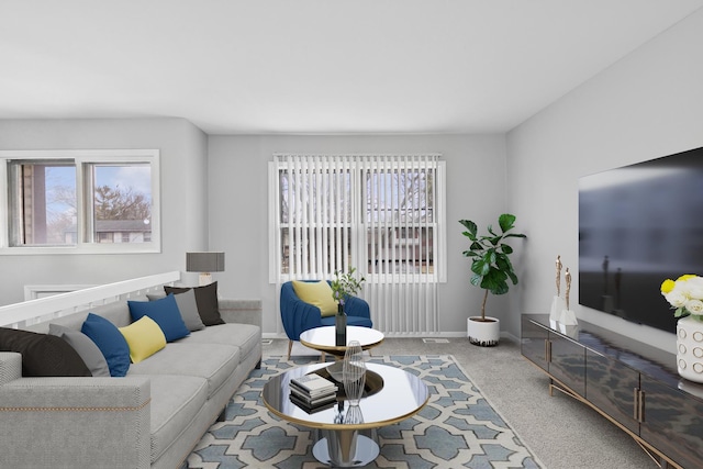 living room with carpet floors and a healthy amount of sunlight