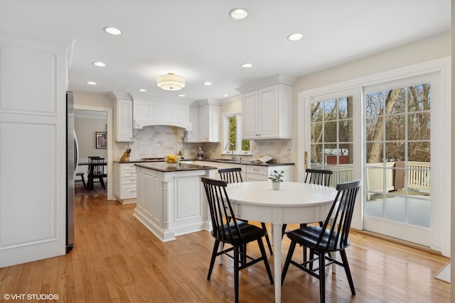 dining room featuring sink and light hardwood / wood-style floors