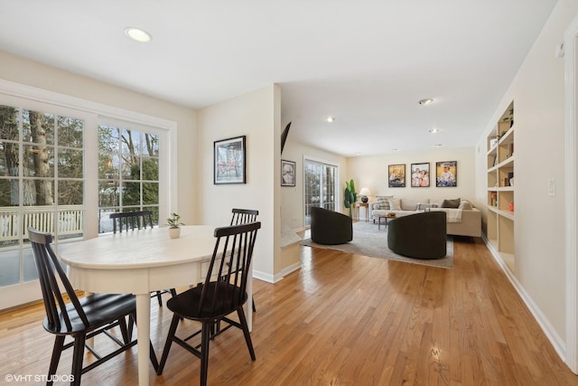 dining space with light hardwood / wood-style flooring