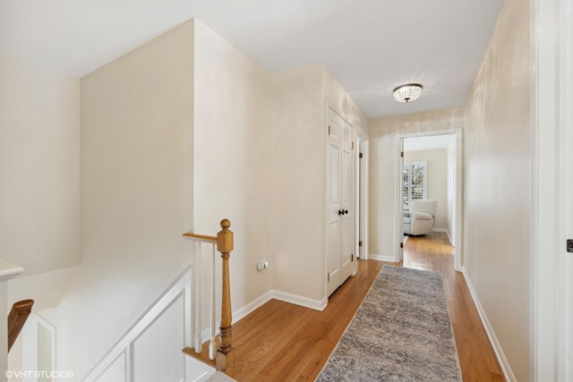 hallway with light hardwood / wood-style floors