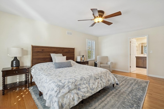 bedroom with connected bathroom, hardwood / wood-style floors, and ceiling fan