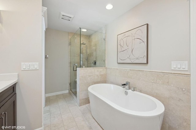 bathroom featuring tile patterned floors, vanity, and separate shower and tub