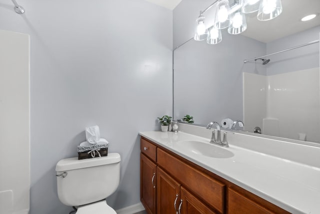 bathroom featuring a shower, toilet, and vanity