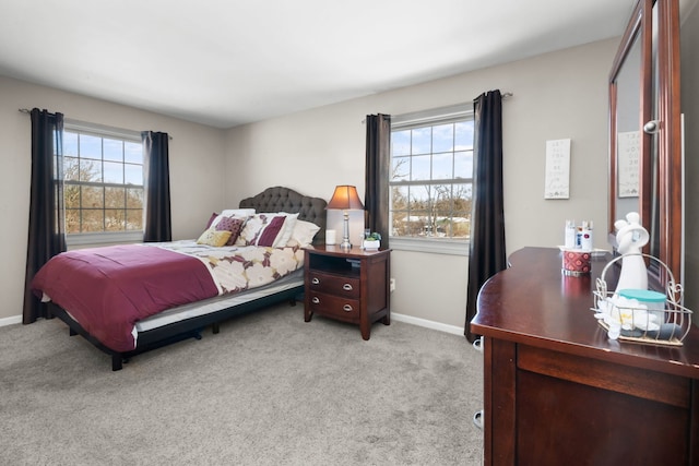 carpeted bedroom with multiple windows